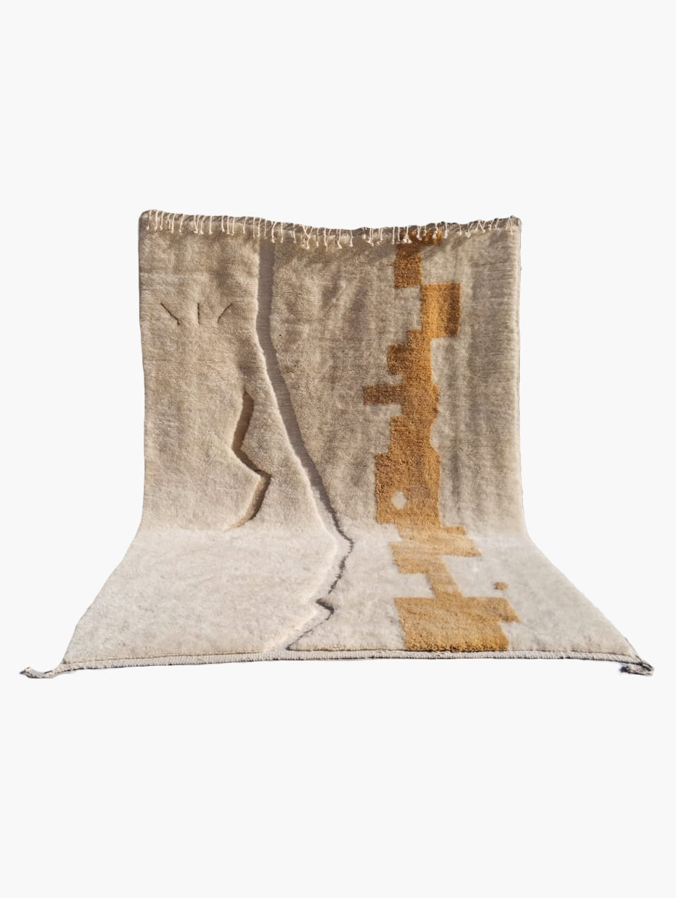 A rectangular wool rug with an abstract motif in saffron yellow and beige tones, featuring a visible textured border.